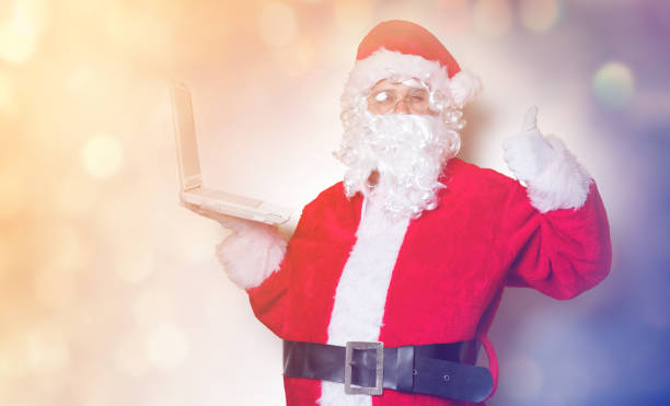 istock Funny Santa Claus have a fun with laptop 845946370