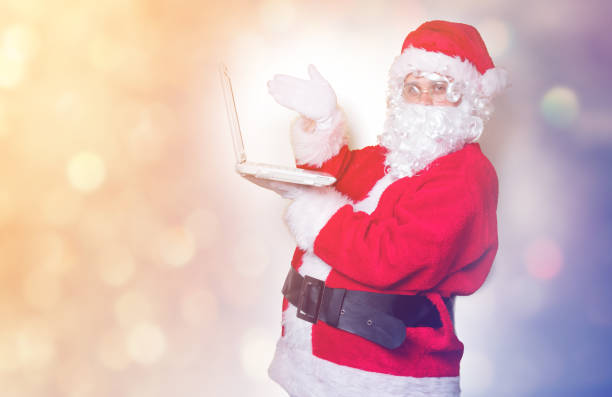 istock Funny Santa Claus have a fun with laptop 845946372