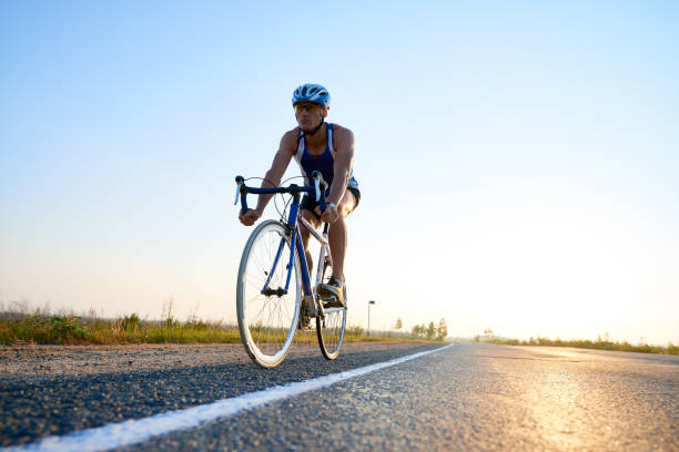 istock Ambitious man cycling on road 845950930