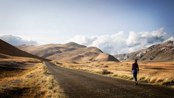 Young woman walking on a mountain road