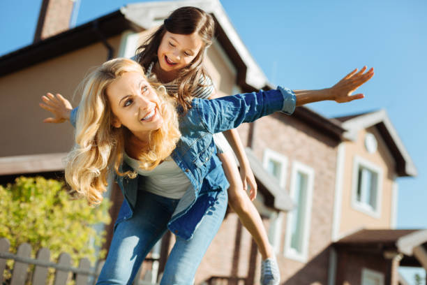 istock Happy mother carrying her daughter on back 845954372