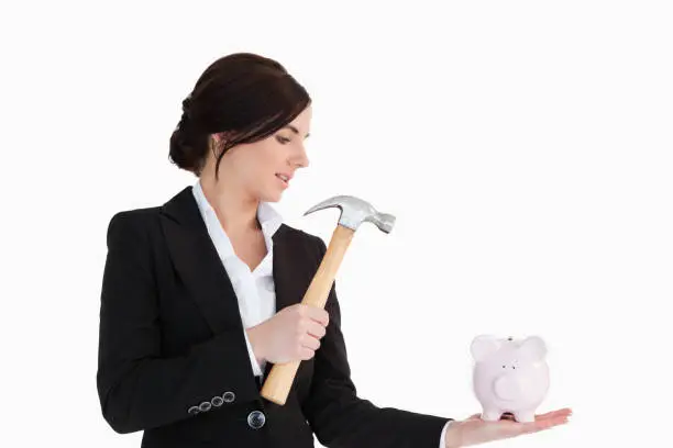 Photo of Businesswoman going to break a piggybank