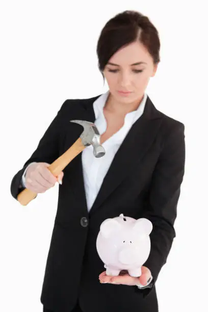 Photo of Woman in suit going to break a piggybank