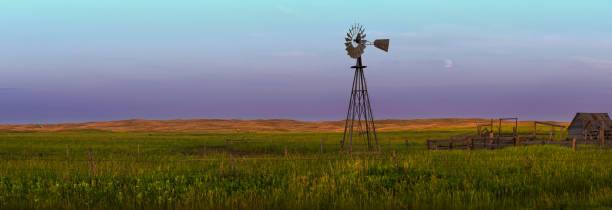 4 Seasons Western Nebraska Sand Hills Landscape With Windmill Single windmill located in the Sand Hills of Western Nebraska. nebraska stock pictures, royalty-free photos & images