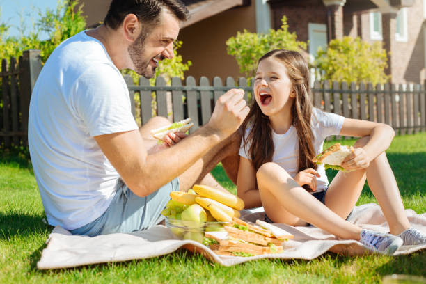 istock Caring father feeding grapes to her little daughter 845956172