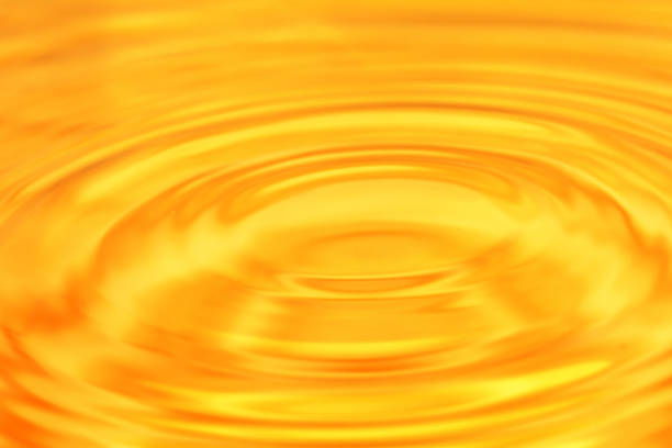 istock abstract background. A drop of water falls in gold 845958510