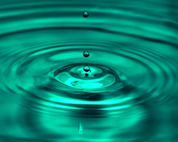 istock a drop of water falling into the water. macro 845958698