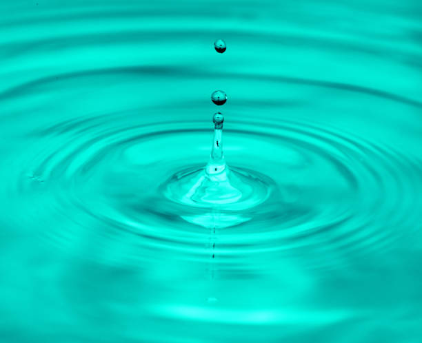 istock a drop of water falling into the water. macro 845958790