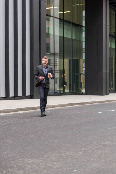 istock Older businessman walking down the street 845962132
