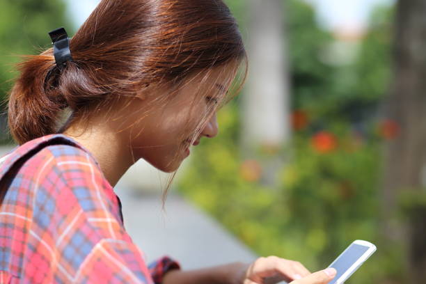 istock Young girl using smartphone in Vietnam 845967568