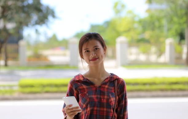 istock Young girl using smartphone in Vietnam 845969444