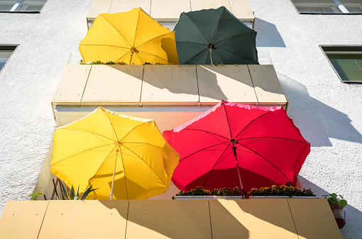 balconies in the summer with colorful parasols