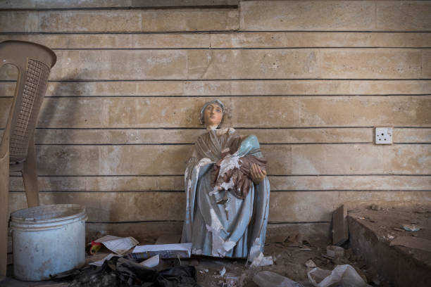 Damaged Virgin Mary statue in Qaraqosh, Iraq Qaraqosh, Iraq - May 5, 2017: A damaged statue of the Virgin Mary, the head placed back onto the body, sits inside a church in Qaraqosh, Iraq. A predominately Christian town, Qaraqosh was taken by ISIS in 2014 and then retaken from ISIS in October 2016. So far few families have returned to the town. islamic state stock pictures, royalty-free photos & images