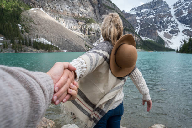 istock Couple holding hands at mountain lake 845973778