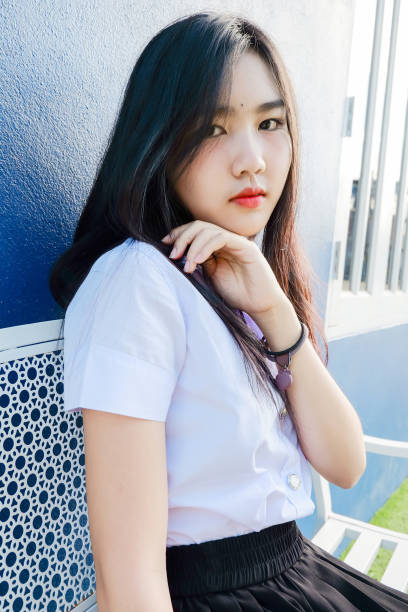 istock young student girl in school uniform sit on 845980066