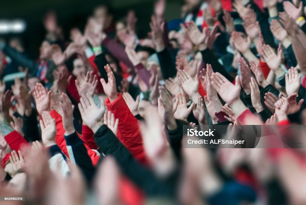 Football fans clapping on the podium of the stadium Fan - Enthusiast Stock Photo