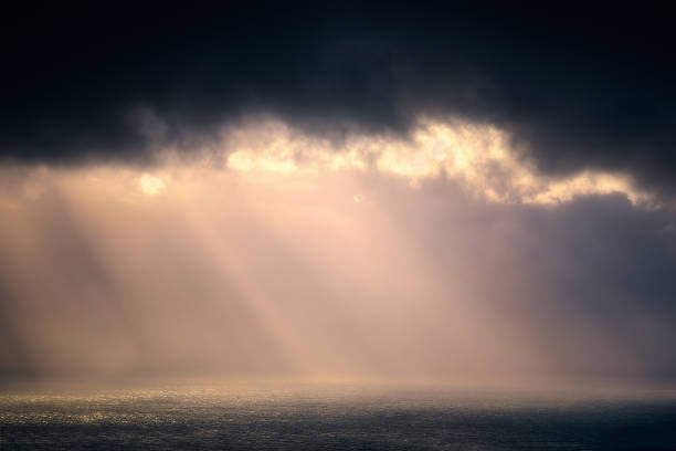 istock rain on the sea with stormy clouds and sun rays 845980778