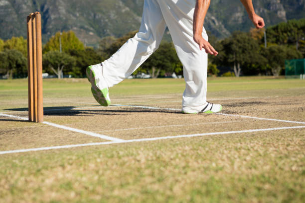istock Low section of player standing by stumps at cricket field 845984614