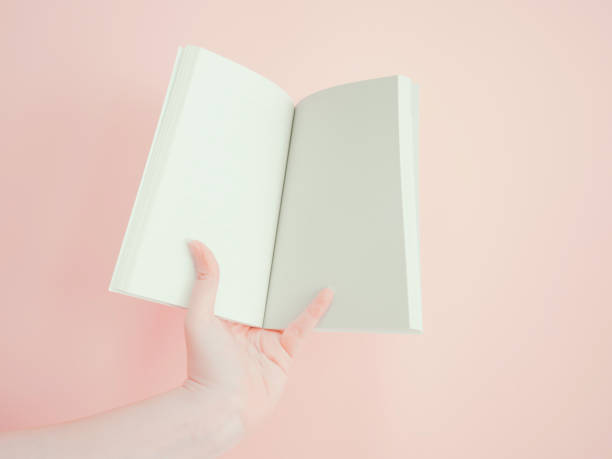 istock asian woman hold , open and present her book or document display by one hand with pink pastel background 845984936