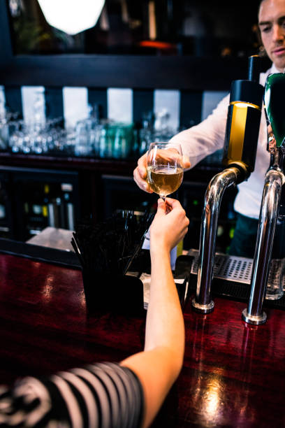 istock Barman giving a drink to customer 845988162