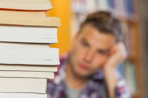 istock Student studying between piles of books 845988482