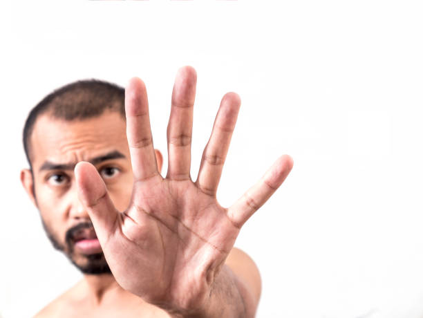 istock Asian man showing stop hand sign on white background 845989056
