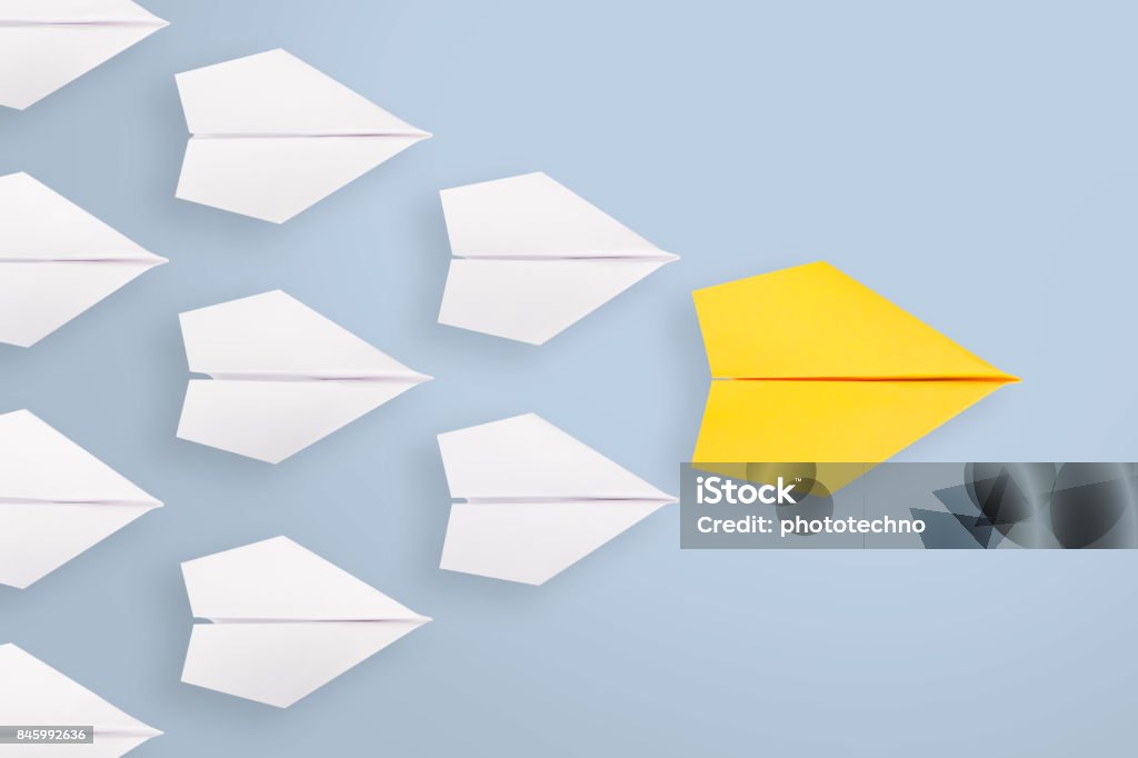 Leadership concepts with yellow paper plane leading among white Morality Stock Photo
