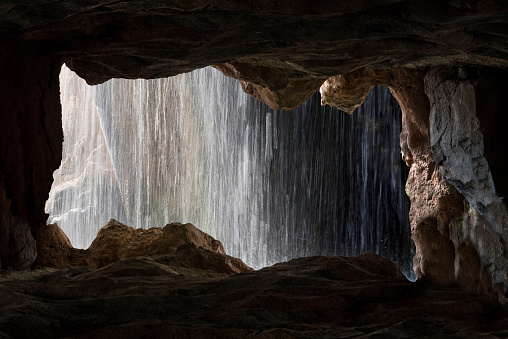 View of the waterfall from the cave inside in Valencia, Spain.