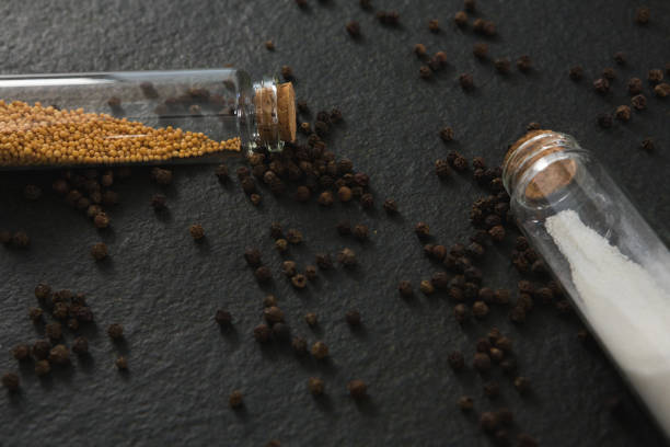Overhead of salt and pepper shaker on black background