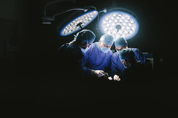 grupo de cirujanos en el trabajo en sala de operaciones. - performance surgery doctor men fotografías e imágenes de stock