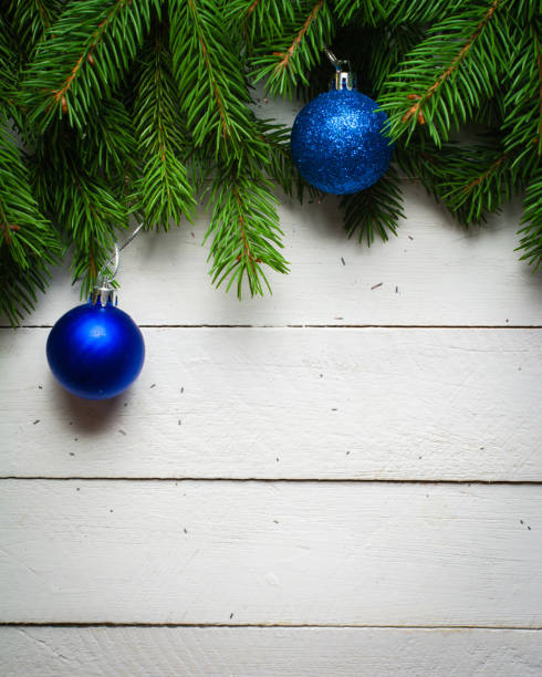 istock Christmas and New Year background. Christmas tree branch on a white planc background. View from above. 846003160