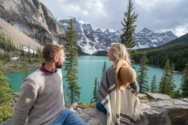 istock Young couple enjoying mountain lake scenery 846006084