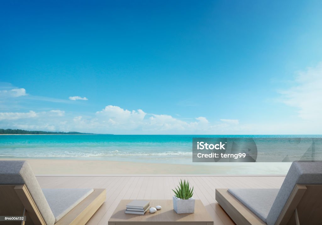 Sea view terrace and beds in modern luxury beach house with blue sky background, Lounge chairs on wooden deck at vacation home or hotel 3d rendering of outdoor furniture on wooden floor Beach Stock Photo