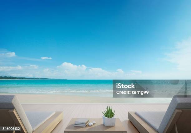 Sea View Terrace And Beds In Modern Luxury Beach House With Blue Sky Background Lounge Chairs On Wooden Deck At Vacation Home Or Hotel Stock Photo - Download Image Now