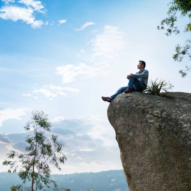 istock A man sitting on cliff enjoy the view 846006186