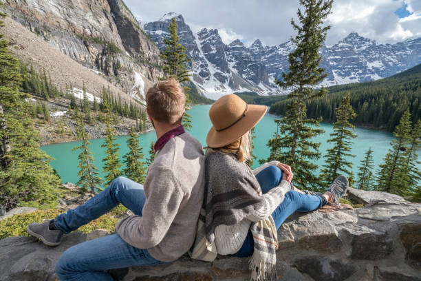 istock Young couple enjoying mountain lake scenery 846006222