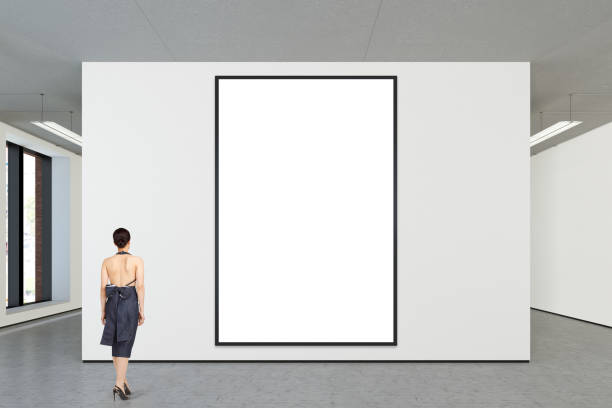 istock Woman looking at blank poster in modern gallery 846007696