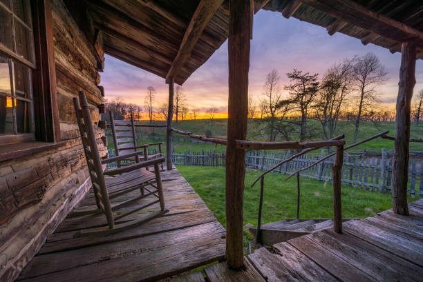 Rustic proch and scenic sunset. Beautiful evening light seen from the front porch of an old rustic cabin in the Cumberland Gap National Park. front porch stock pictures, royalty-free photos & images
