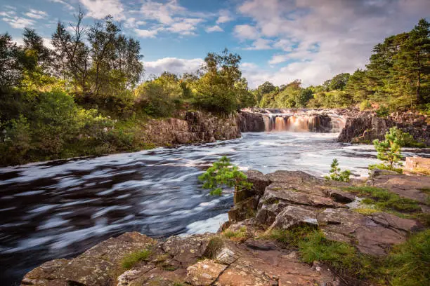 The River Tees cascades over the Whin Sill at Low Force Waterfall, as the Pennine Way follows the southern riverbank