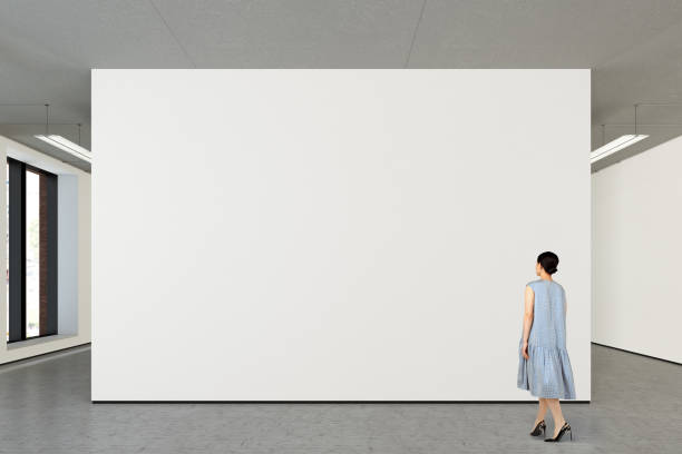 istock Woman looking at blank poster in modern gallery 846010542