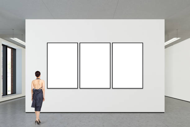 istock Woman looking at blank poster in modern gallery 846011438
