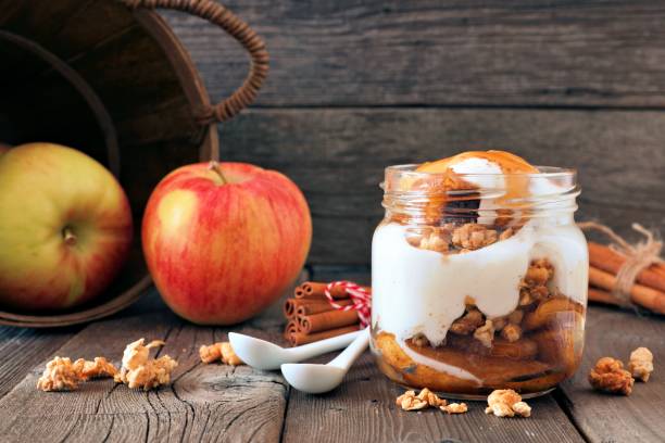 istock Baked apple parfait with caramel in a mason jar on rustic wood 846011492