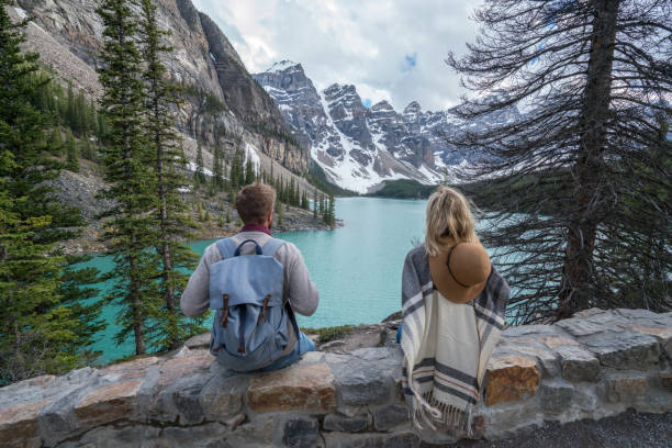 istock Young couple enjoying mountain lake scenery 846011496