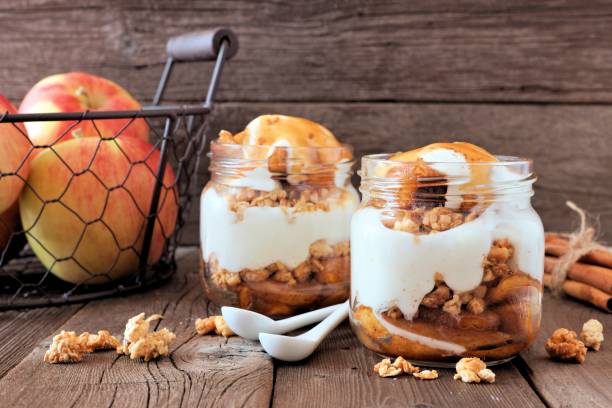 istock Baked apple parfaits with caramel in mason jars on rustic wood 846011552