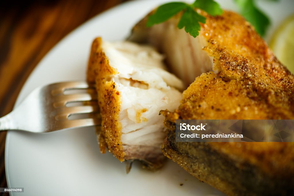 catfish roasted in batter catfish roasted in batter on a wooden table Catfish Stock Photo