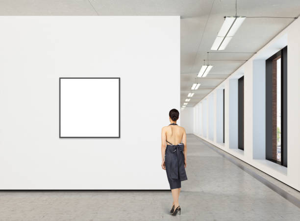 istock Woman looking at blank poster in modern gallery 846015122