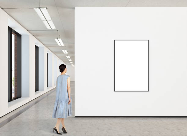 istock Woman looking at blank poster in modern gallery 846015238
