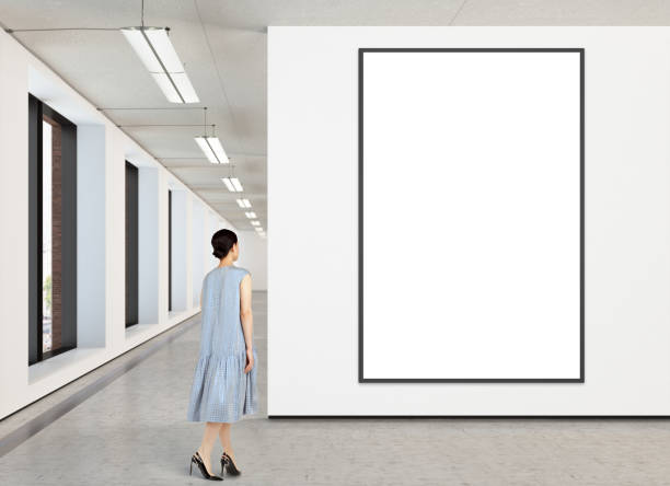 istock Woman looking at blank poster in modern gallery 846015428