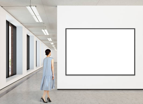 istock Woman looking at blank poster in modern gallery 846016820