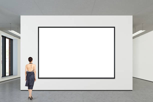 istock Woman looking at blank poster in modern gallery 846017774